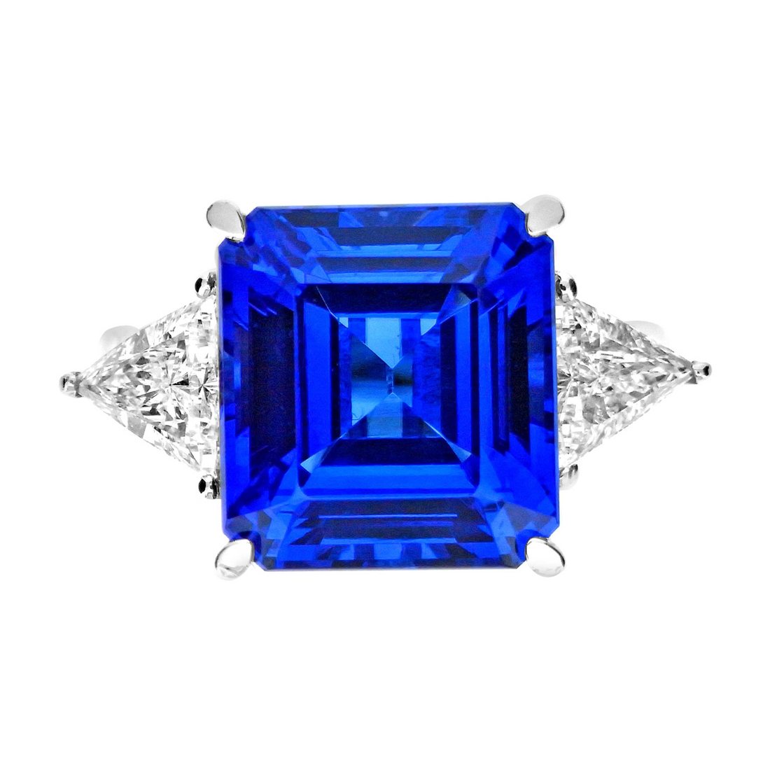 Octagonal tanzanite flanked by trillion-cut diamonds.
